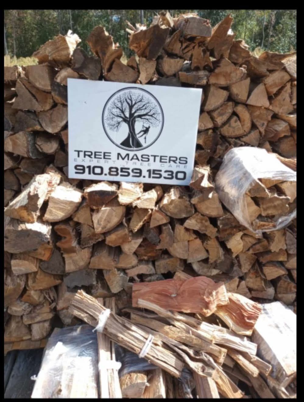 Stacked seasoned firewood produced from a Tree Masters job